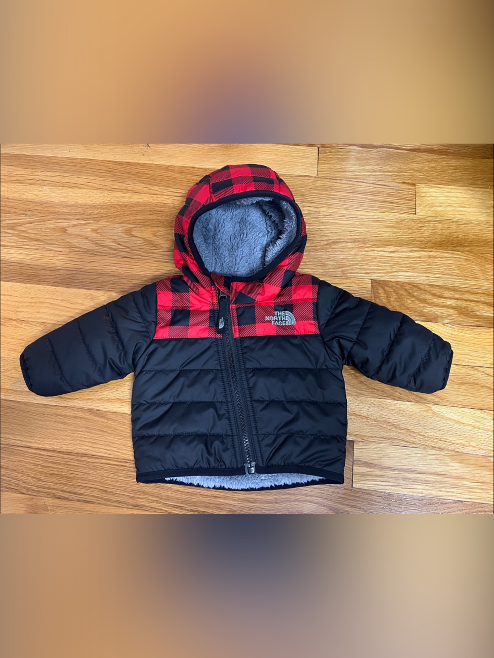 The North Face Kids Puffer Jacket in Black with Red Buffalo Plaid Hood